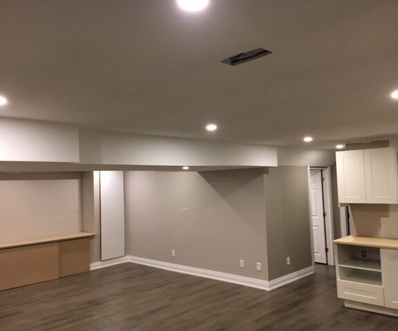 basement-finishing-toronto-low-ceiling-basement-with-build-in-storage-unit-and-small-kitchen-b...jpg