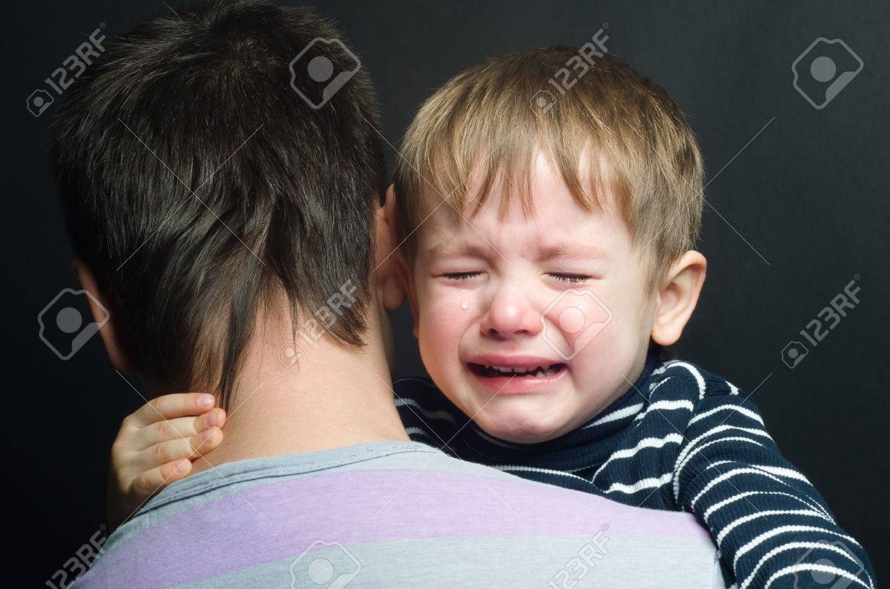 24965648-crying-child-in-the-arms-of-his-father.jpg