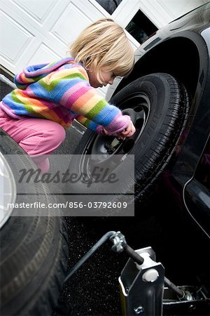 856-03792609em-2-3-year-old-girl-changing-a-flat-tire--Cumberland--Maine-.jpg