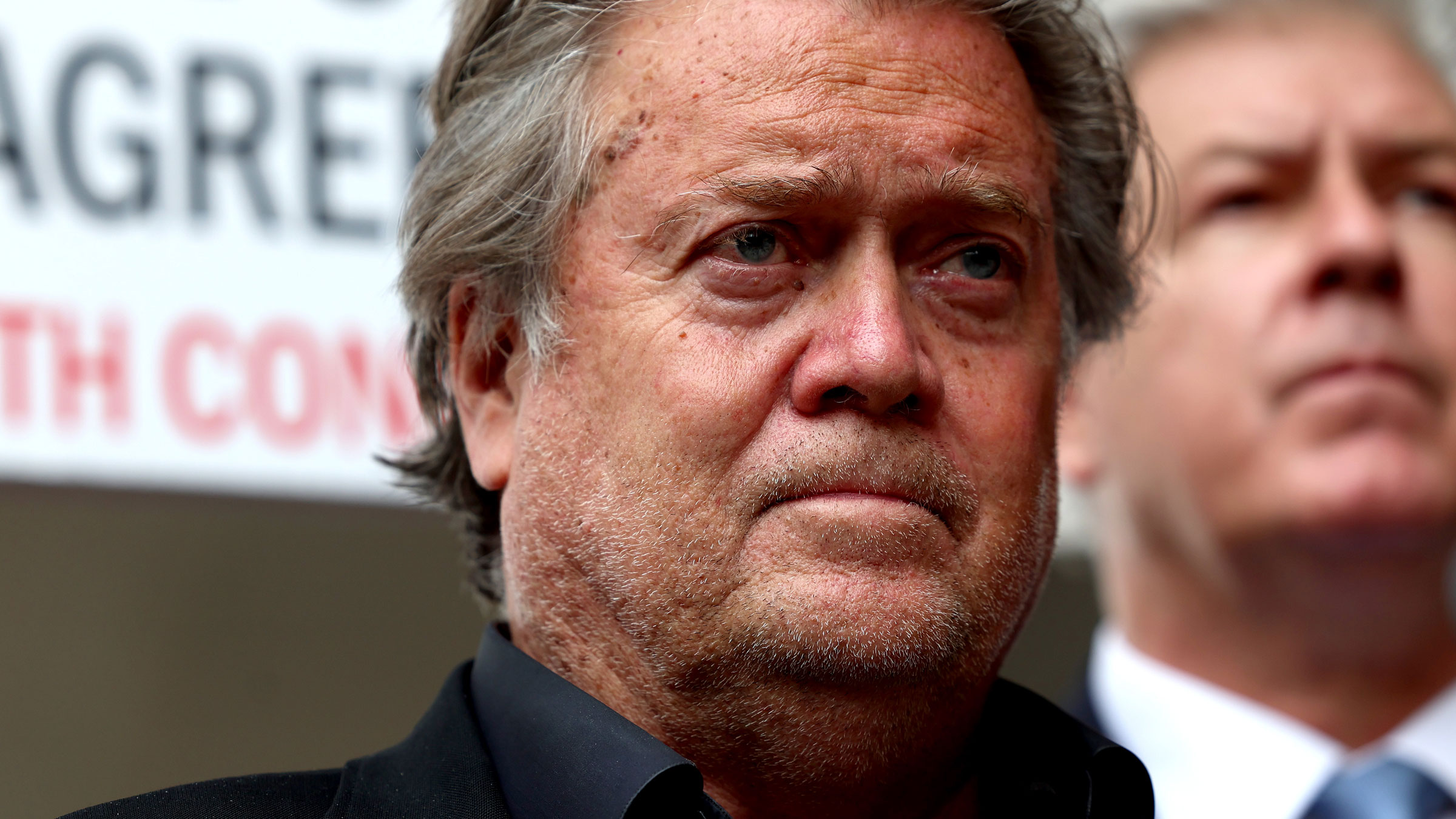 Steve Bannon speaks to reporters on Thursday, a day before he was found guilty.