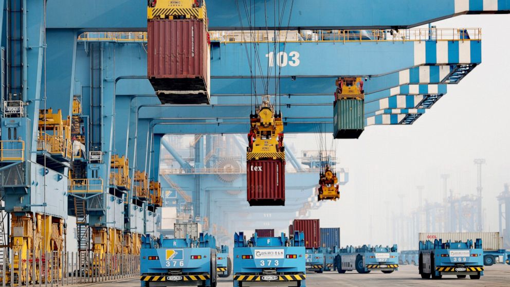 FILE - Driverless vehicles move shipping containers at a port in Qingdao in eastern China's Shandong Province, on Jan. 6, 2022. China’s exports rose 15.7% in March, 2022, over a year earlier while imports were flat due to disruptions from coronavirus
