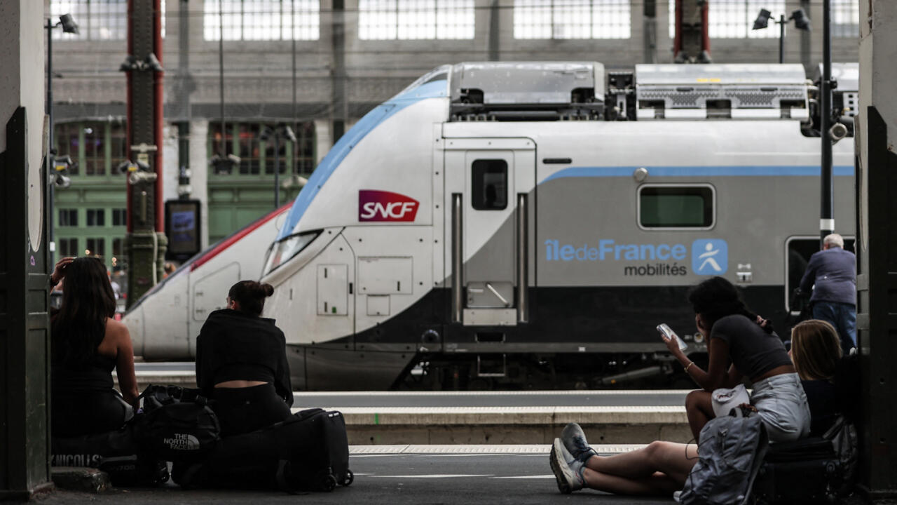 Passengers wait for their train departures on a platform at Gare de Lyon train station in Paris, on July 31, 2024.