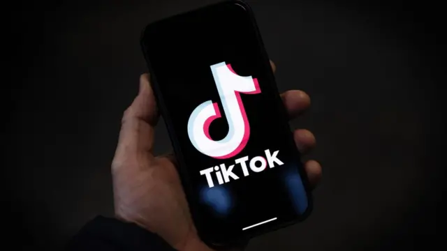 TikTok logo on smartphone screen TikTok logo on smartphone screen