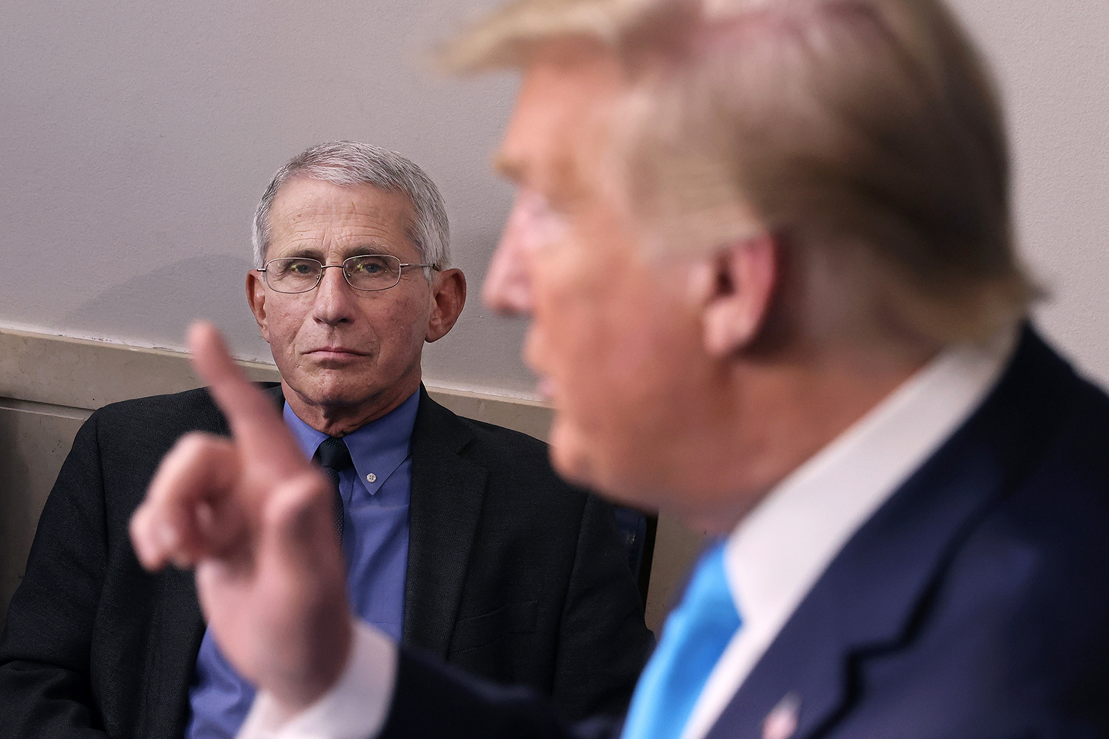 Dr. Anthony Fauci, director of the National Institute of Allergy and Infectious Diseases, listens to President Donald Trump speak to reporters at the White House in Washington, DC, on April 7, 2020.