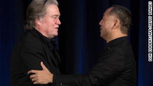 Former White House Chief Strategist Steve Bannon (L) greets fugitive Chinese billionaire Guo Wengui before introducing him at a news conference on November 20, 2018 in New York.