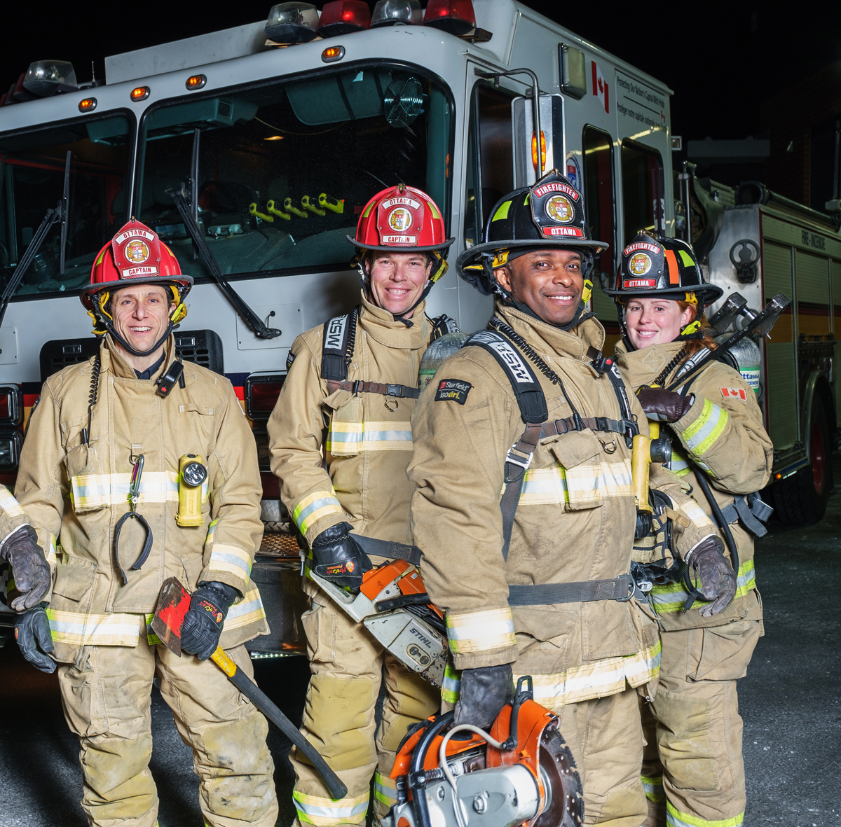 Four firefighters dressed in full bunker gear