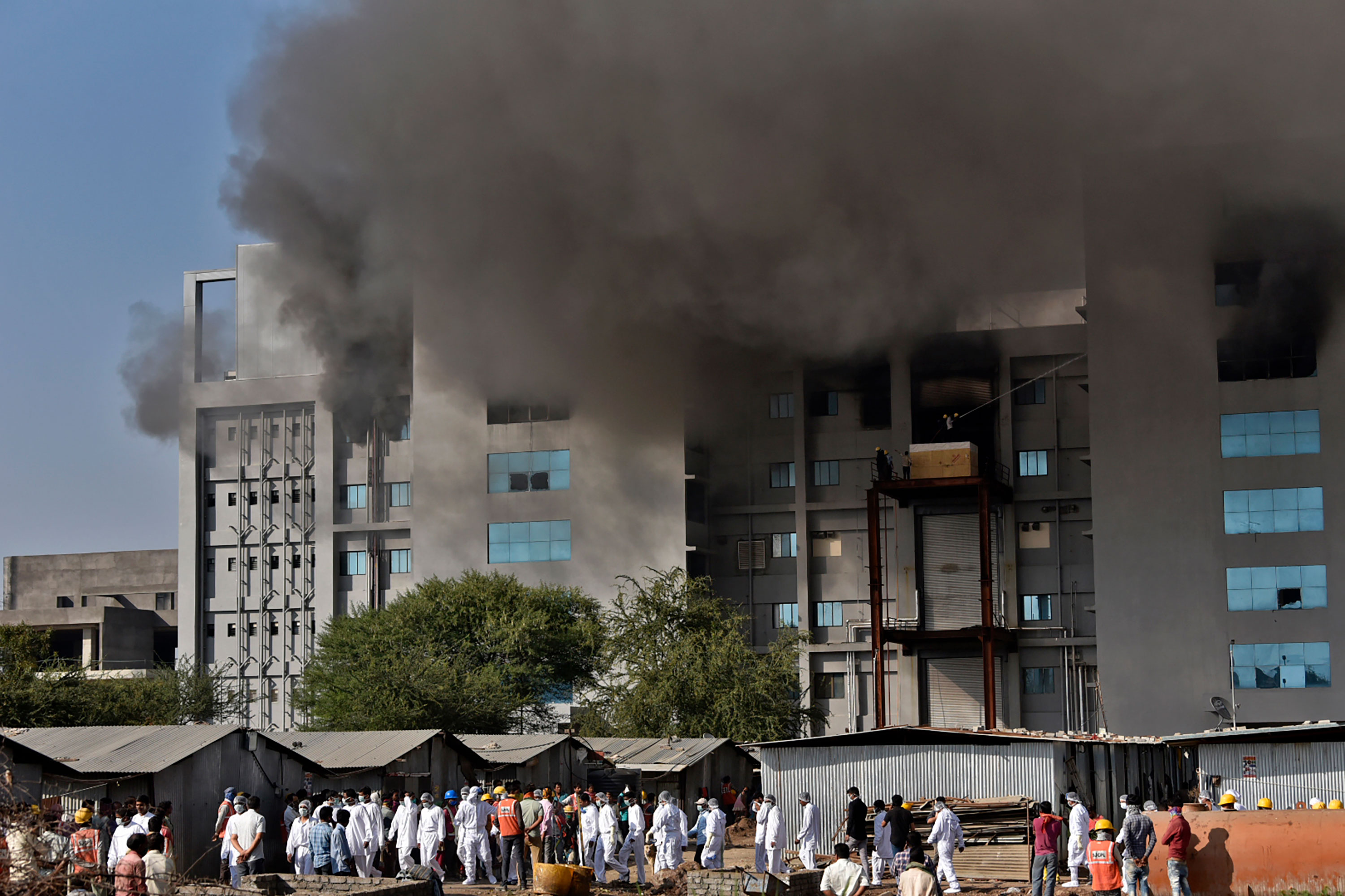 Workers are seen after a fire broke out at India's Serum Institute in Pune on January 21.