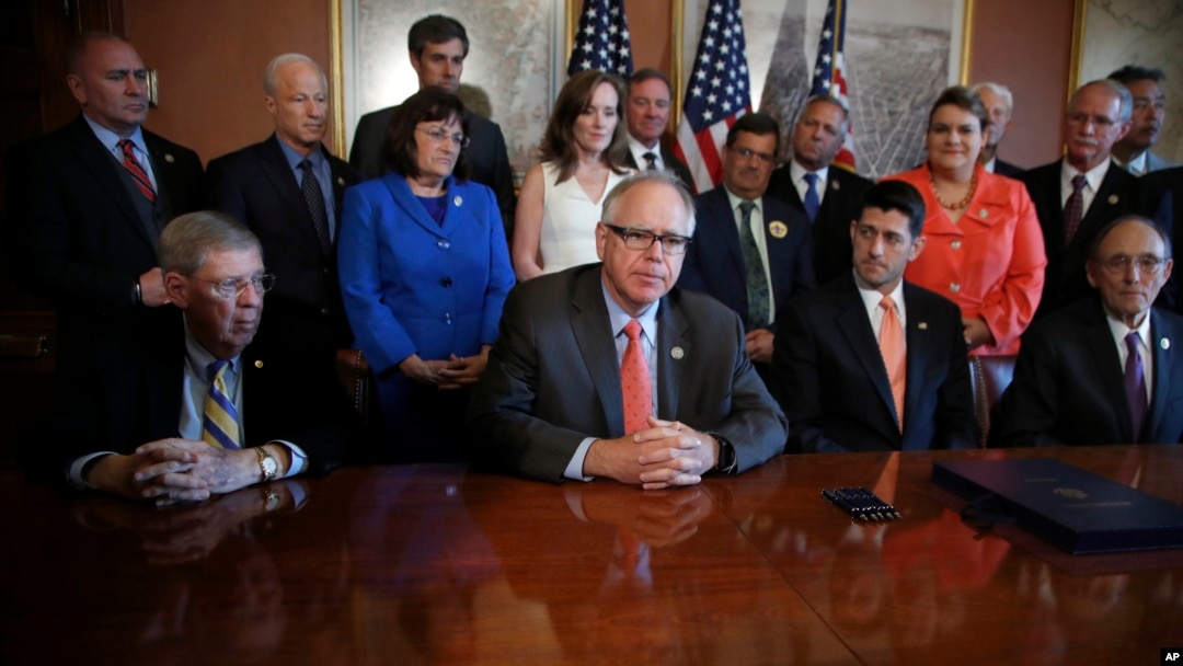 FILE - House Speaker Paul Ryan of Wisconsin, with House Veterans' Affairs Committee Chairman Rep. Phil Roe, Senate Veterans' Affairs Chairman Sen. Johnny Isakson, and other committee members, listen to Rep. Tim Walz, on Capitol Hill, June 21, 2017.