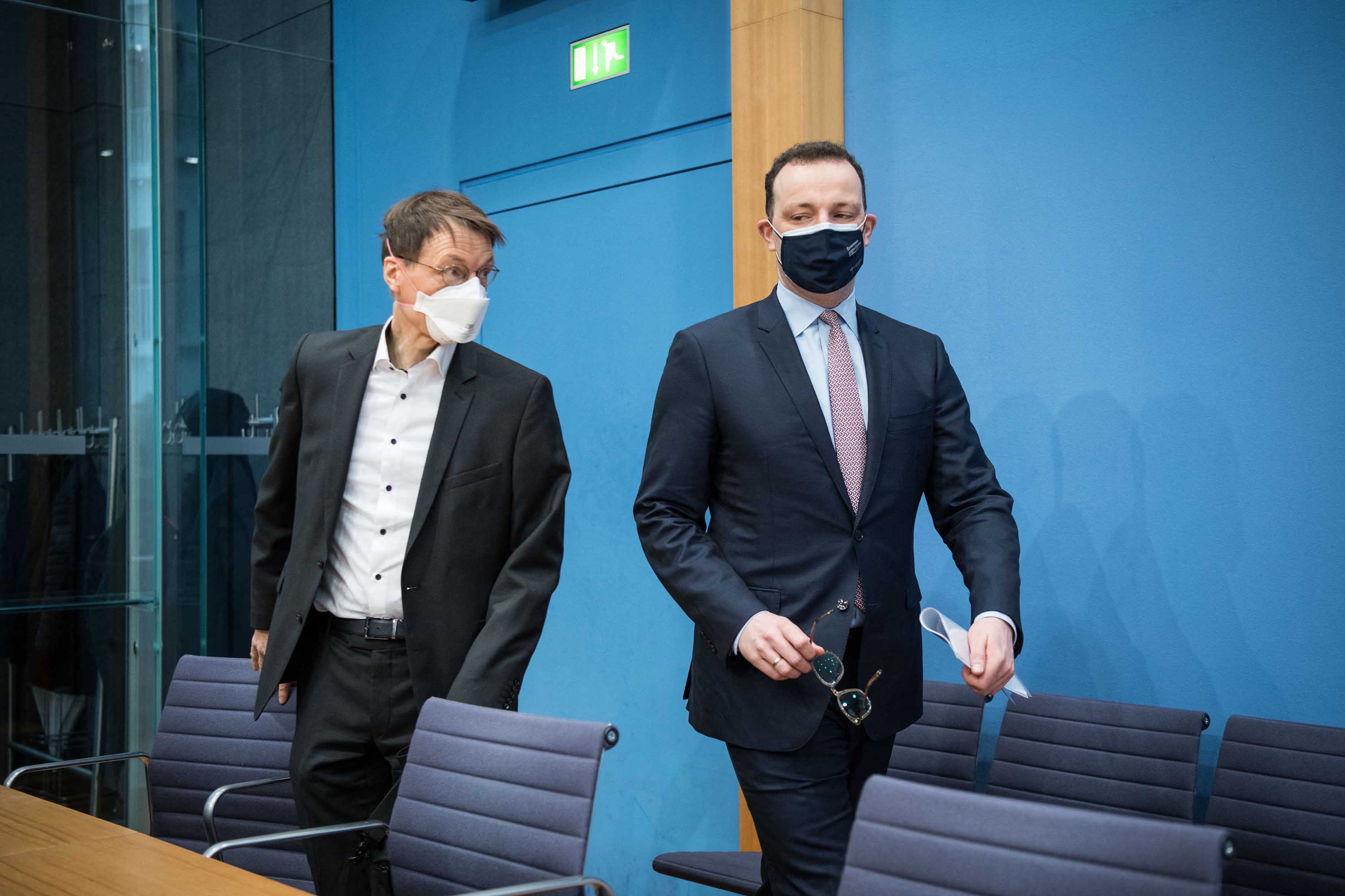 German Health Minister Jens Spahn, right, and German public health expert Karl Lauterbach arrive for a news conference on March 19, in Berlin. 