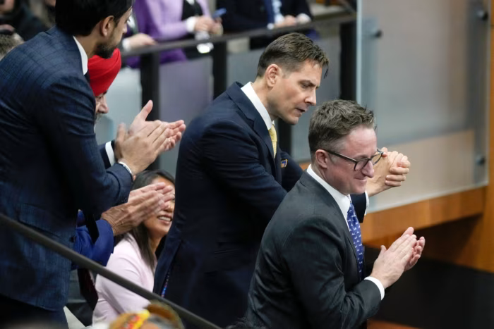 Michael Kovrig, second from right, and Michael Spavor, right, react as President Joe Biden acknowledges them during a speech to the Canadian parliament earlier this year