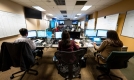 The Emergency Operation Centre with representatives from each department coordinate the City-wide response around the table, with computers, charts, and televisions.