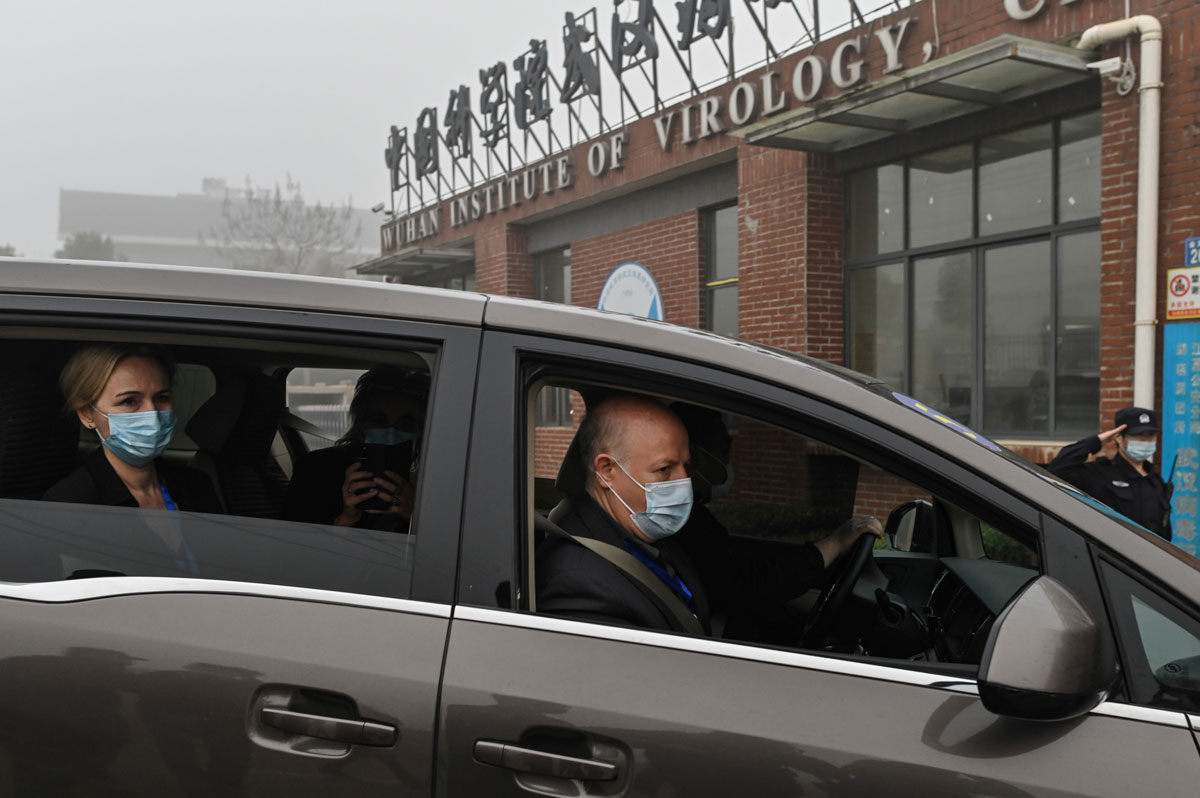 Peter Daszak (r) and other members of the World Health Organization team investigating the origins of the Covid-19 coronavirus, arrive at the Wuhan Institute of Virology on February 3.