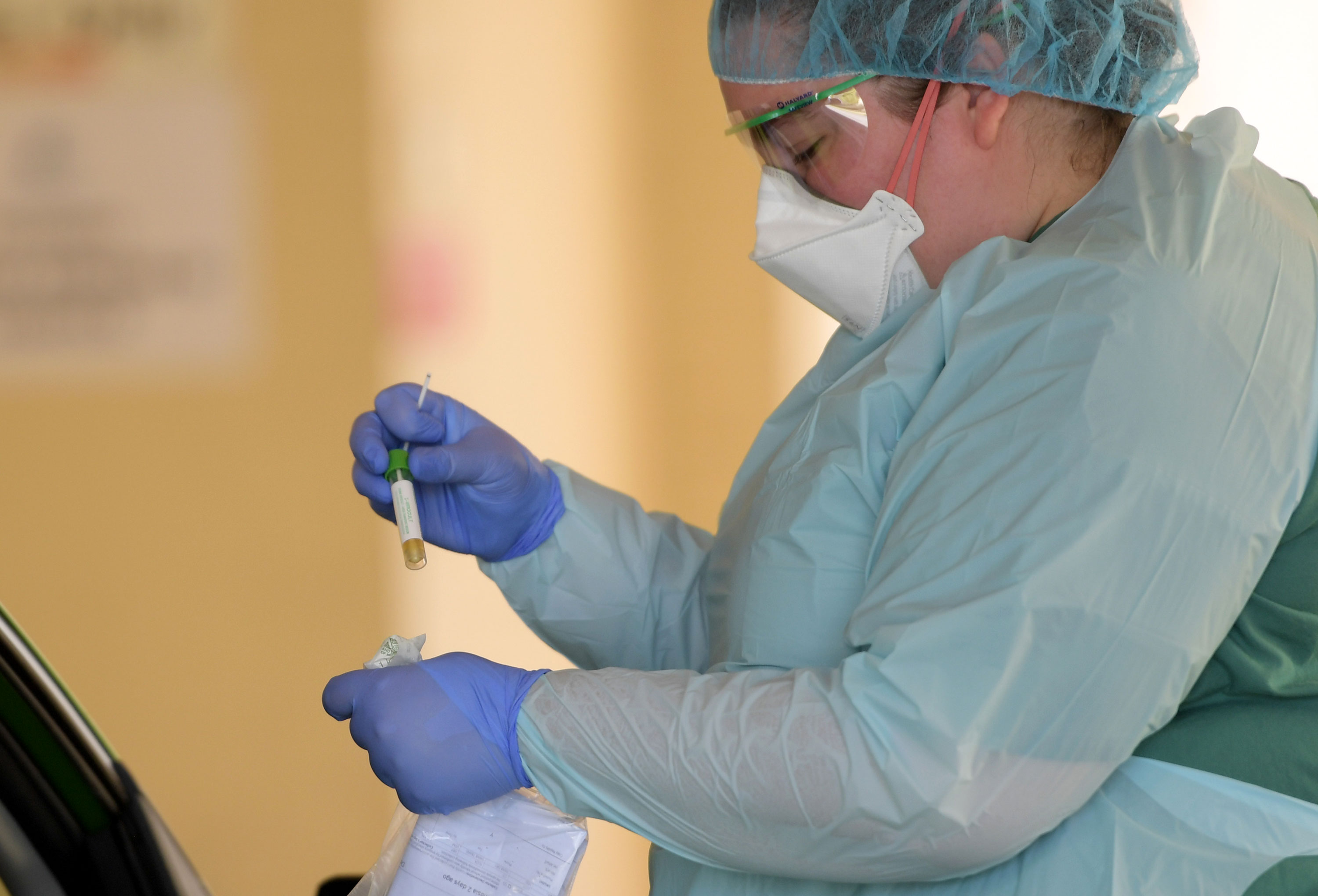 A health worker conducts tests at a coronavirus testing center in Adelaide, Australia on March 11. 