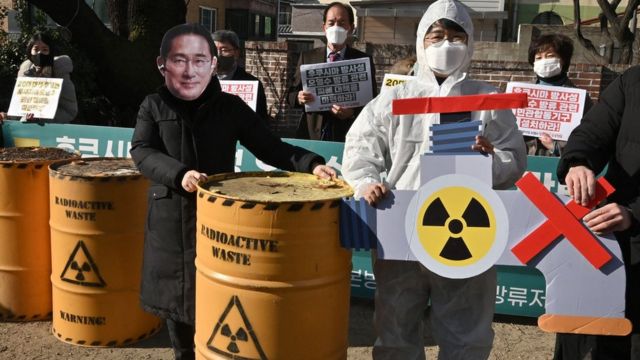 A South Korean environmental activist wearing a mask of Japan's Prime Minister Fumio Kishida (L) performs during a protest against Japan's plan to discharge Fukushima radioactive water into the sea, in Seoul on January 6, 2022.'s Prime Minister Fumio Kishida (L) performs during a protest against Japan's plan to discharge Fukushima radioactive water into the sea, in Seoul on January 6, 2022.