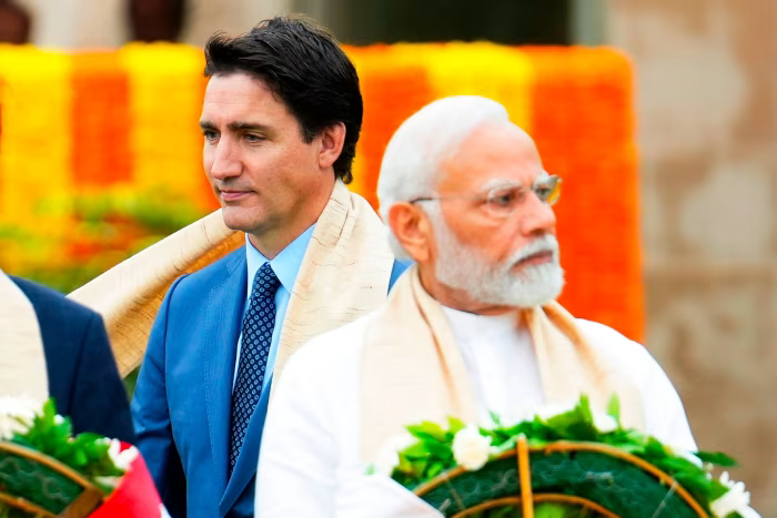 Justin Trudeau walks past his Indian counterpart  Narendra Modi as they take part in a wreath-laying ceremony at Raj Ghat, Mahatma Gandhi’s cremation site, during the G20 summit in New Delhi in September