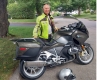 A man beside his motorcycle / Un homme à côté de sa moto