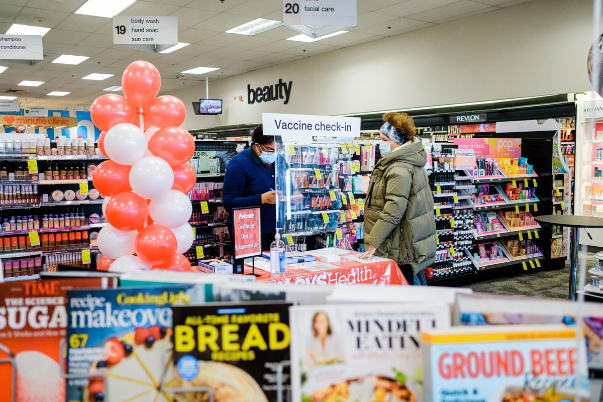 A worker checks in a person with an appointment to receive a dose of the Moderna Covid-19 vaccine at a CVS Pharmacy location in Eastchester, New York on February 12.