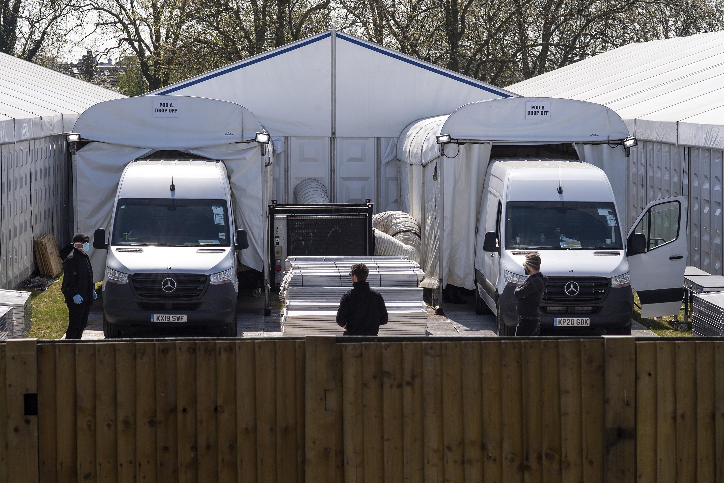 Vans back into drop-off pods at a temporary morgue on Wanstead Flats in London, England, on April 15.