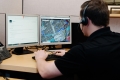 Photo of a call centre agent typing at a computer.