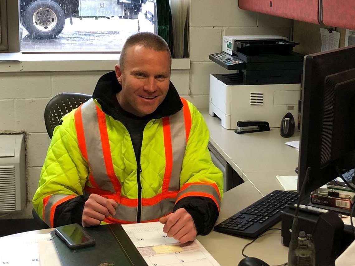 A man in a yellow jumpsuit and safety vest 