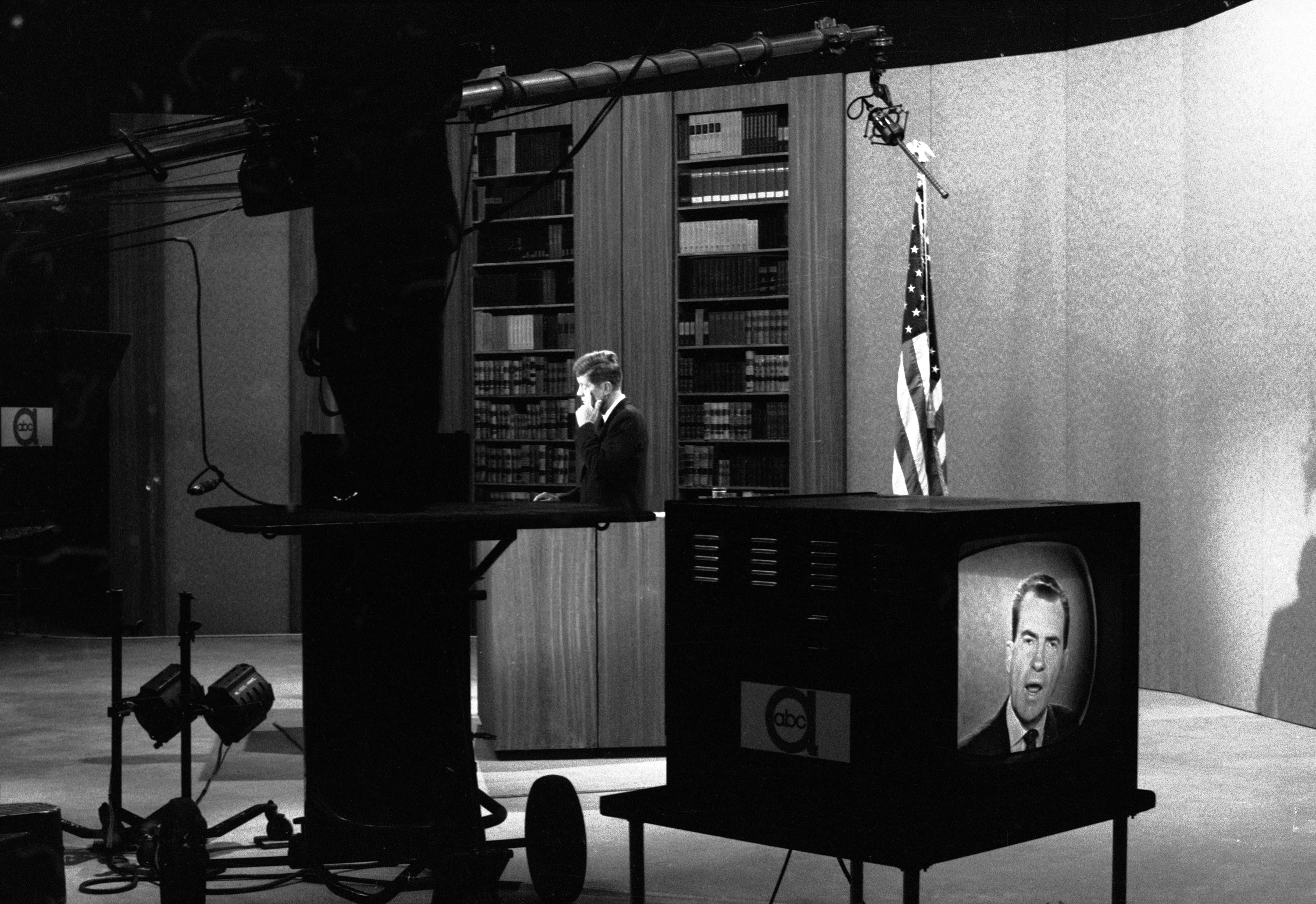 In a studio at ABC television in New York, Sen. John F. Kennedy listens to Vice President Richard M. Nixon who was in a studio in Los Angles on October 13, 1960.