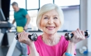 Older woman exercising with dumbbells.