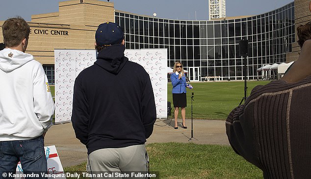 Ernby, center, decried vaccine mandates at a Turning Point USA rally at Irvine City Hall just a month ago