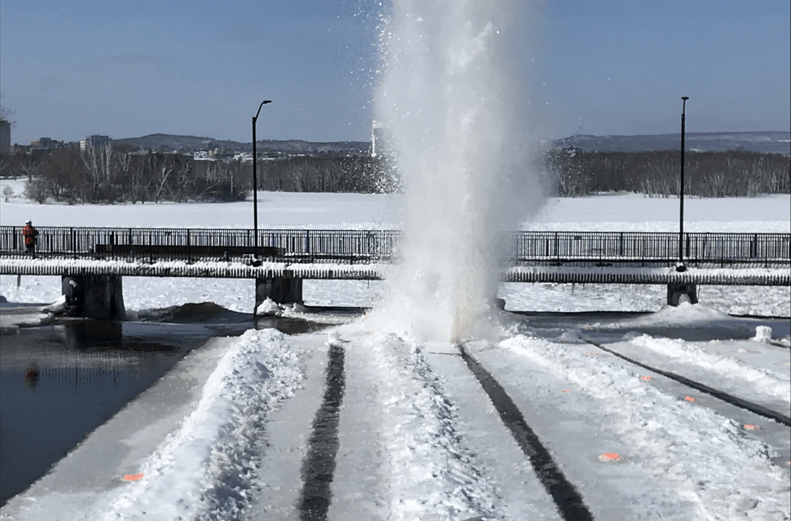 A pre-cut section of ice along the Rideau River being blasted into smaller pieces. 