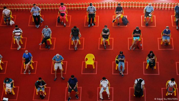 People watch an outdoor movie screening within their social distances in Singapore