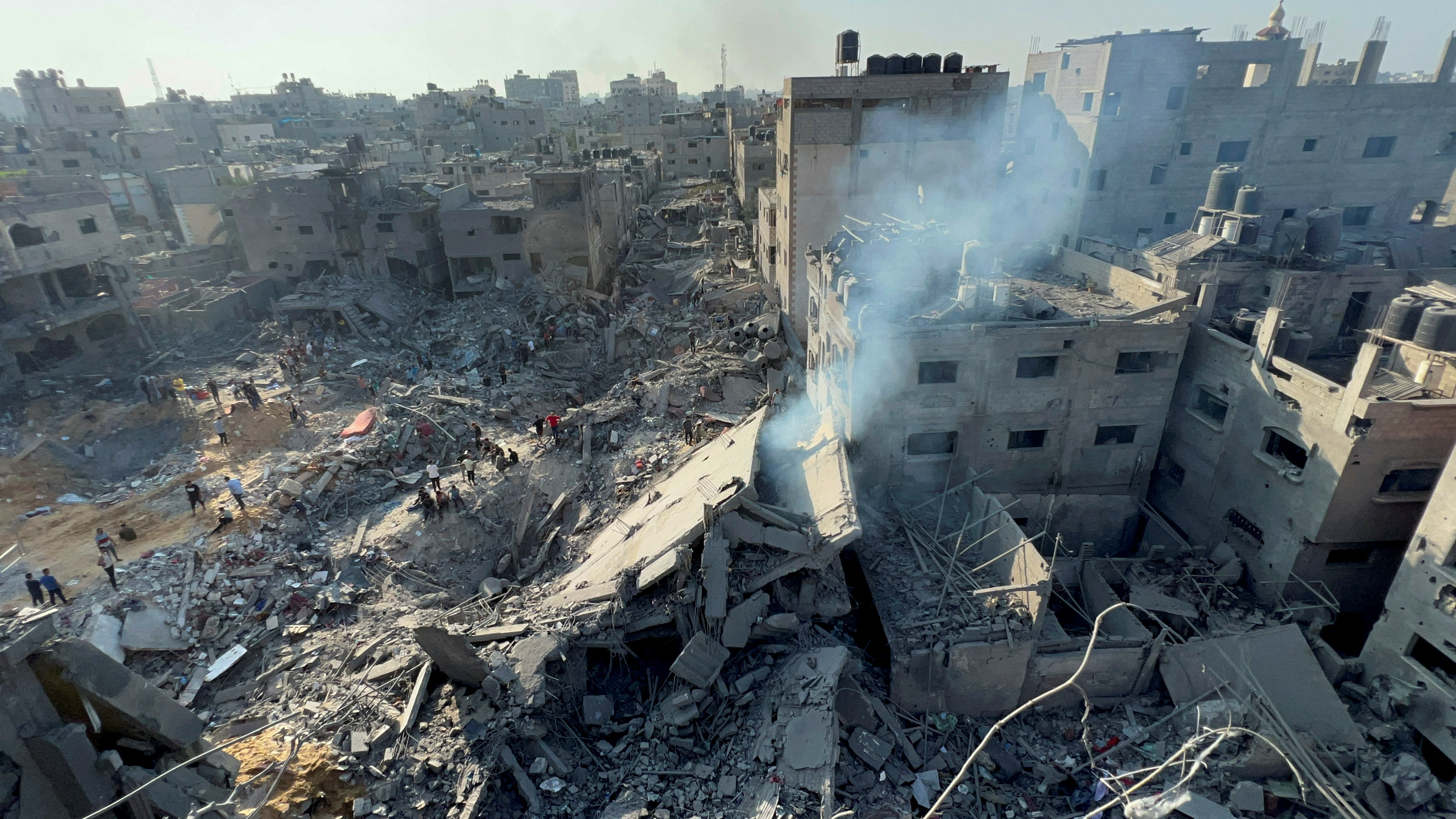Palestinians gather at the site of Israeli strikes on houses in Jabalia refugee camp