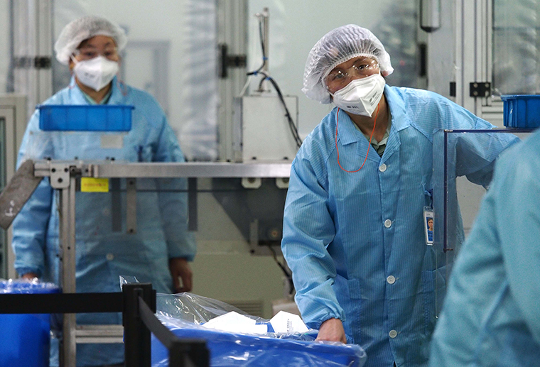  Workers produce KN95 face masks at a 3M mask factory in Shanghai, on March 10.