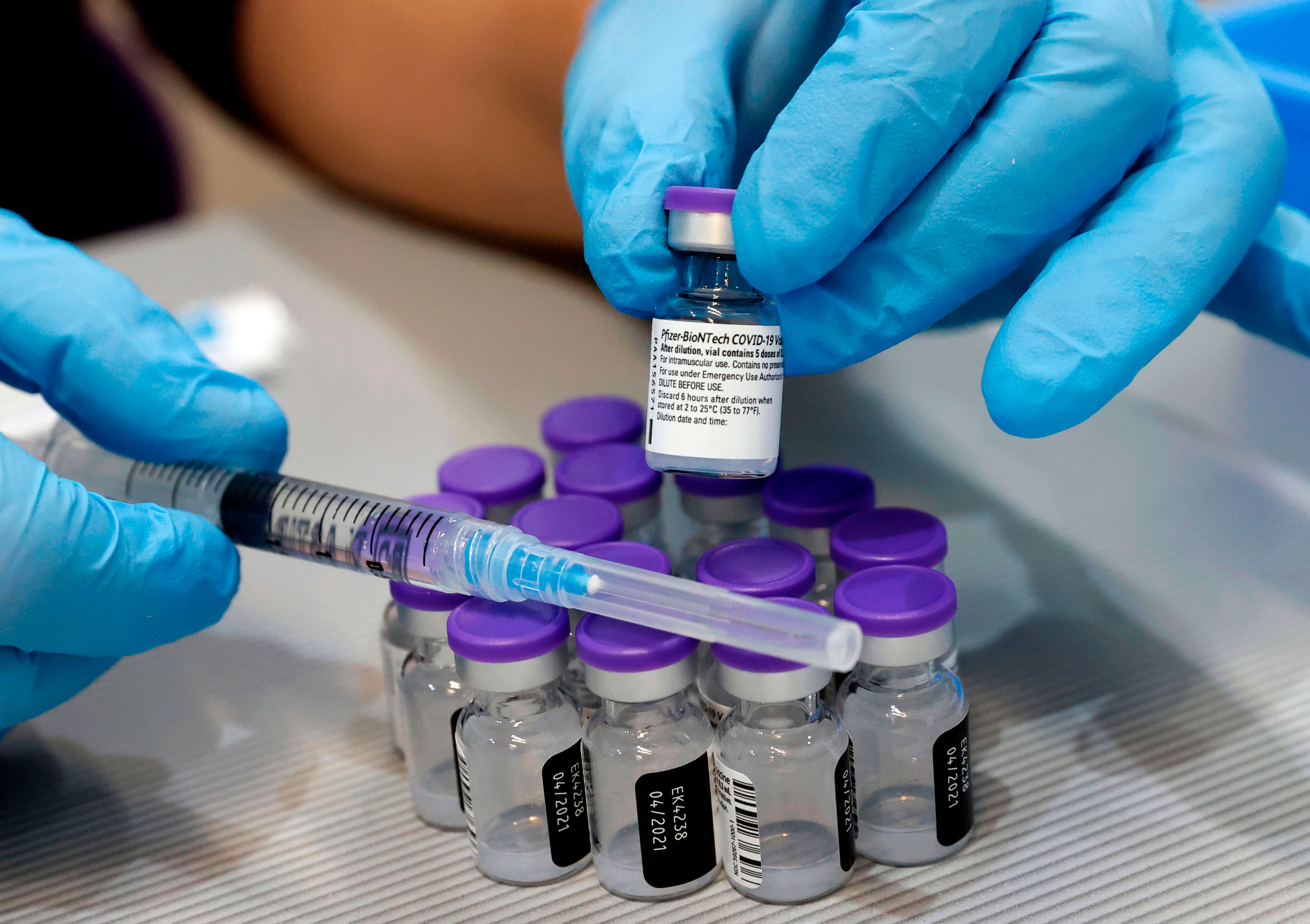 A syringe and vials of the Pfizer/BioNTech Covid-19 vaccine are pictured at the Sheba Medical Center in Ramat Gan, Israel, on January 14.