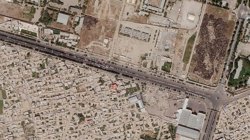 In this satellite photo taken by Planet Labs Inc., a Taliban checkpoint is seen blocking access just south of Kabul's international airport Saturday, Aug. 28, 2021. Taliban forces sealed off Kabul's airport Saturday to most Afghans hoping for evacuat