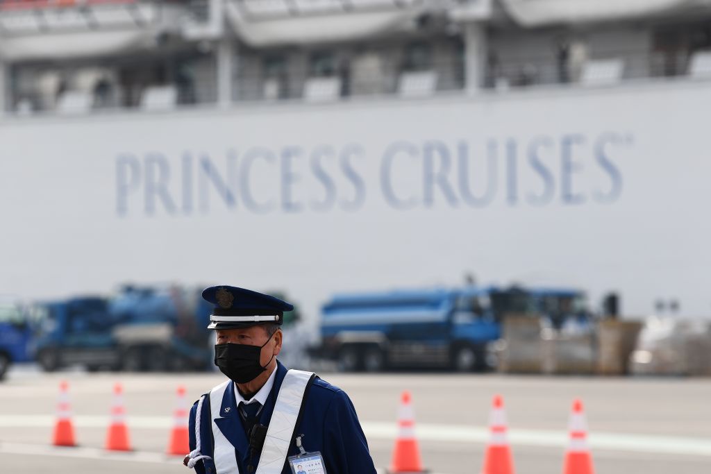 Passengers are seen on balconies of the Diamond Princess cruise ship at the Daikoku Pier Cruise Terminal in Yokohama port on February 14, 2020.