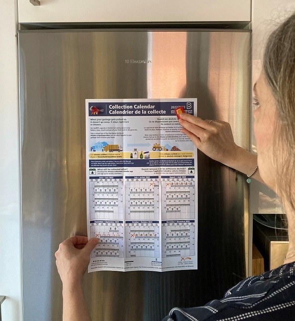 A calendar attached to a fridge with magnets