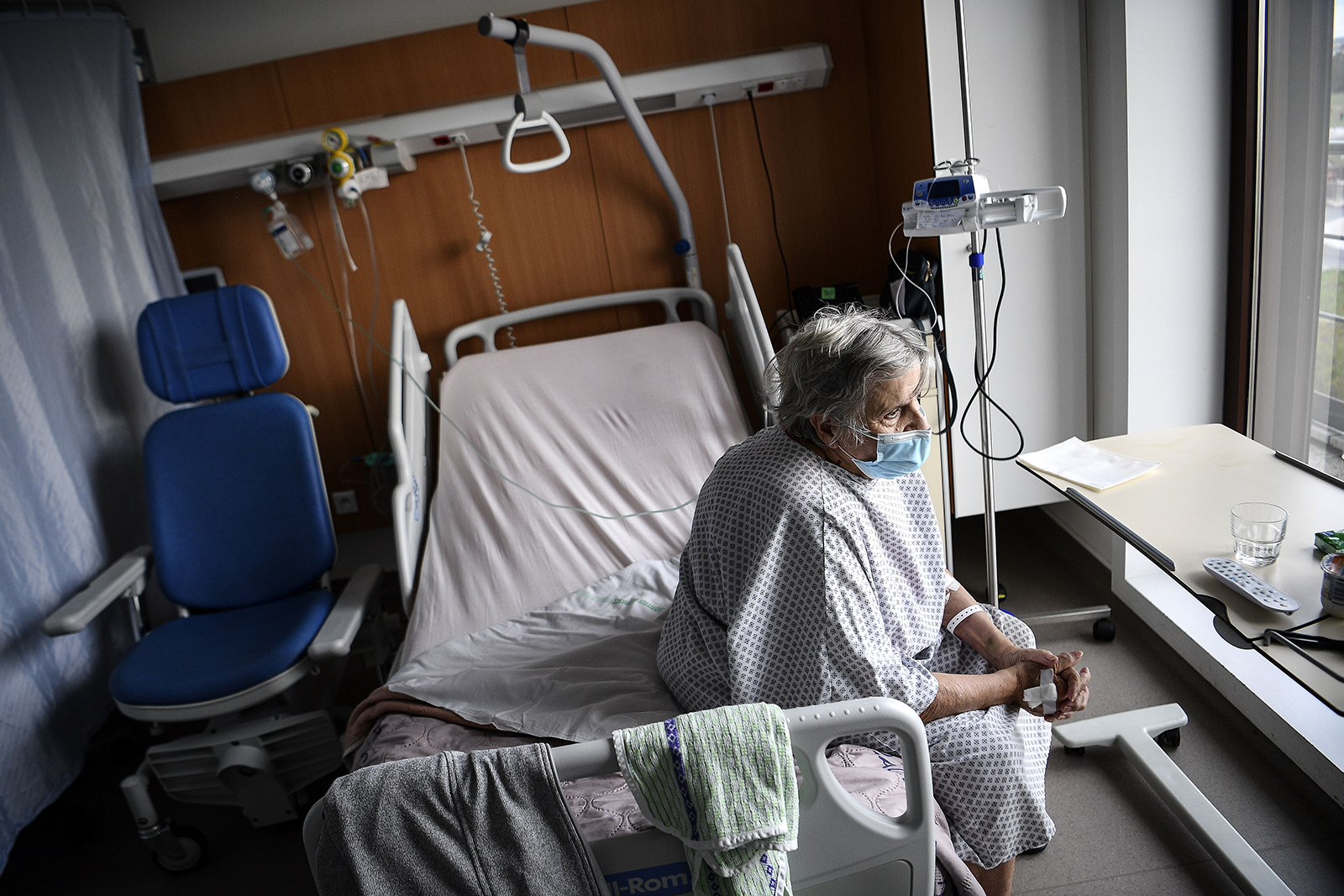 A patient infected with Covid-19 sits on her bed in the infectious diseases unit of the Gonesse hospital in Gonesse, north of Paris, on October 22.