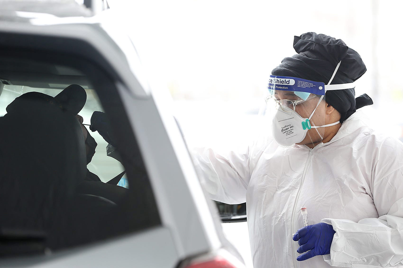 A medical worker administers a Covid-19 test at Rockland High School on Saturday, February 21, in Rockland, Massachusetts. 