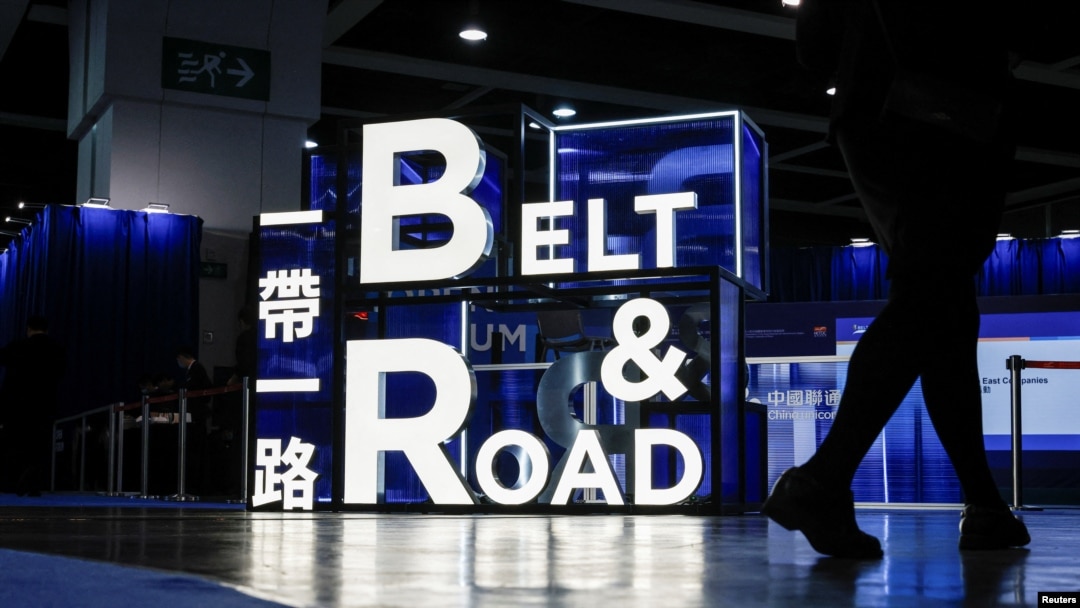 A woman walks in front of a sign at the Belt and Road summit in Hong Kong, China Sept. 14, 2023.