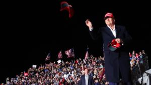 FLORENCE, ARIZONA - JANUARY 15: Former President Donald Trump tosses a MAGA hat to the crowd before speaking at a rally at the Canyon Moon Ranch festival grounds on January 15, 2022 in Florence, Arizona. The rally marks Trump's first of the midterm election year with  races for both the U.S. Senate and governor in Arizona this year. (Photo by Mario Tama/Getty Images)