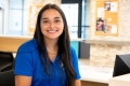 Teresa Donato sitting at a the service desk