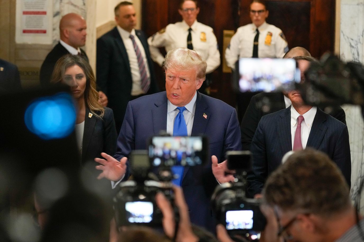 Former President Donald Trump speaks to the media at the New York Supreme Court on Monday. On his way to the courtroom, Trump said the civil fraud trial is a continuation of the single greatest witch hunt of all time. He also called it a scam and a sham. 