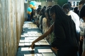 Students review graduation certificates that have been laid out on a table