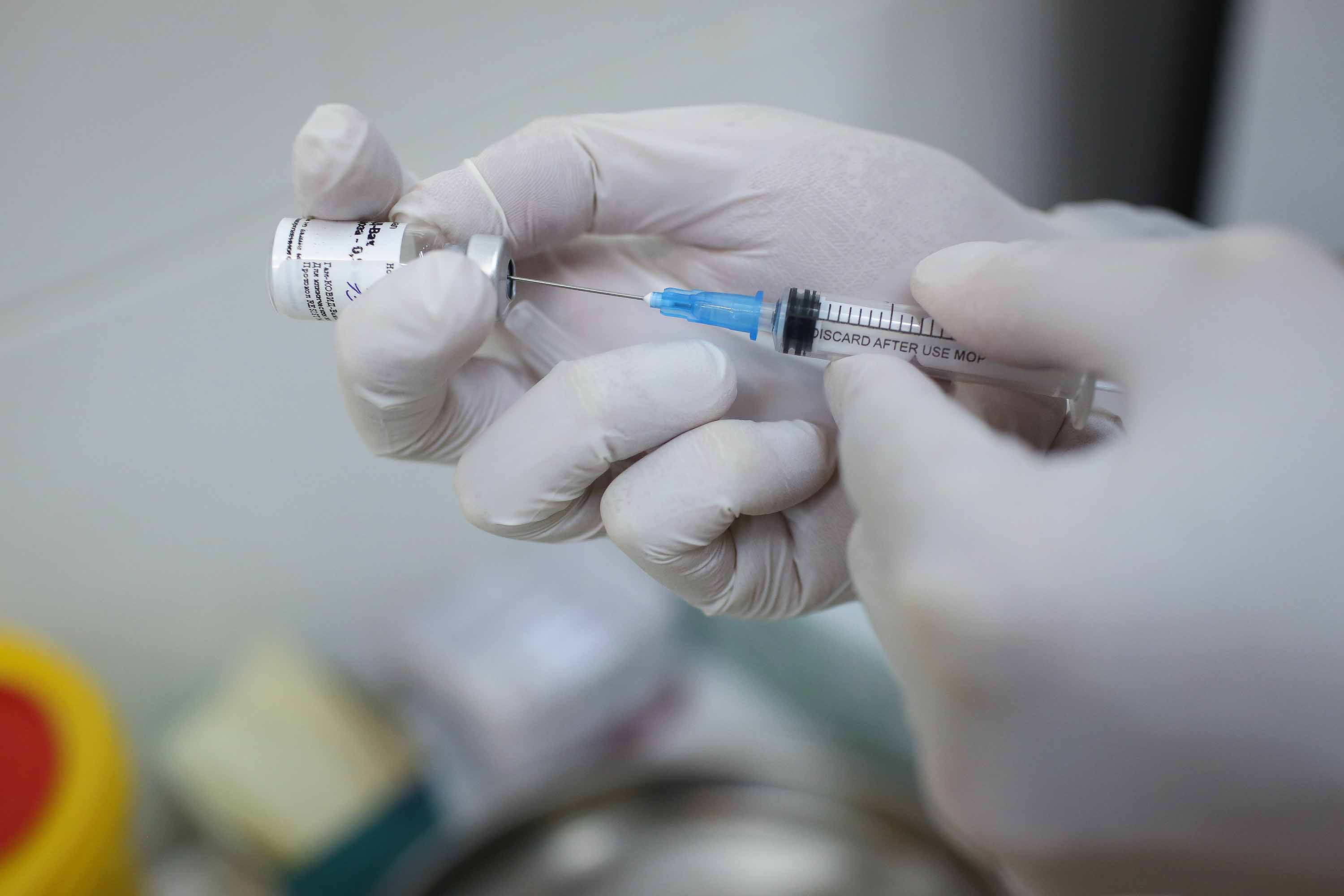 A heath worker draws the vaccine known as 'Sputnik V' from a vial during a trial at a clinic in Moscow, Russia, on September 23.