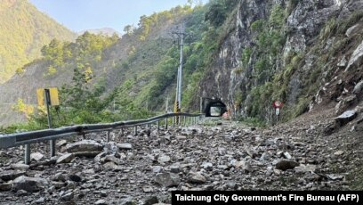 This handout photo from the Taichung City Government's Fire Bureau taken and released on April 3, 2024 shows rocks along part of the road on a section of a highway in Taichung, after a major earthquake hit Taiwan's east. 