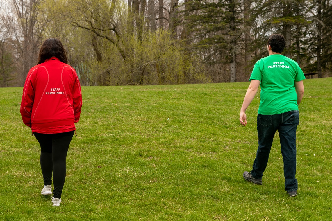 Man in green t-shirt and woman in red jacket