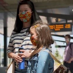 A women and her child in a transit station