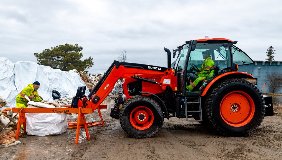 Tractor, workers and sandbags