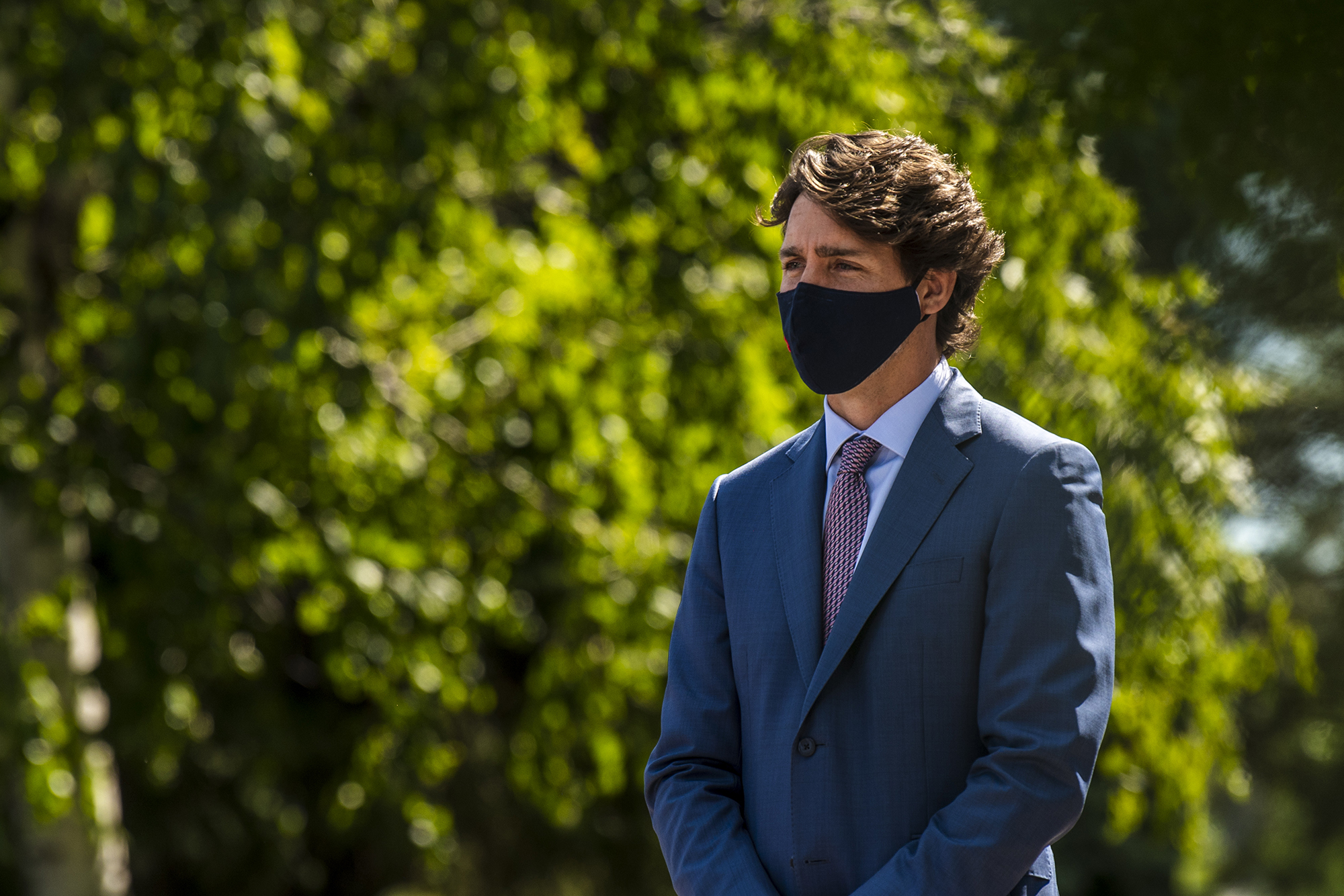 Justin Trudeau, Canada's prime minister, waits to speak at the National Research Council of Canada Royalmount Human Health Therapeutics Research Centre facility in Montreal on Monday, Aug. 31.