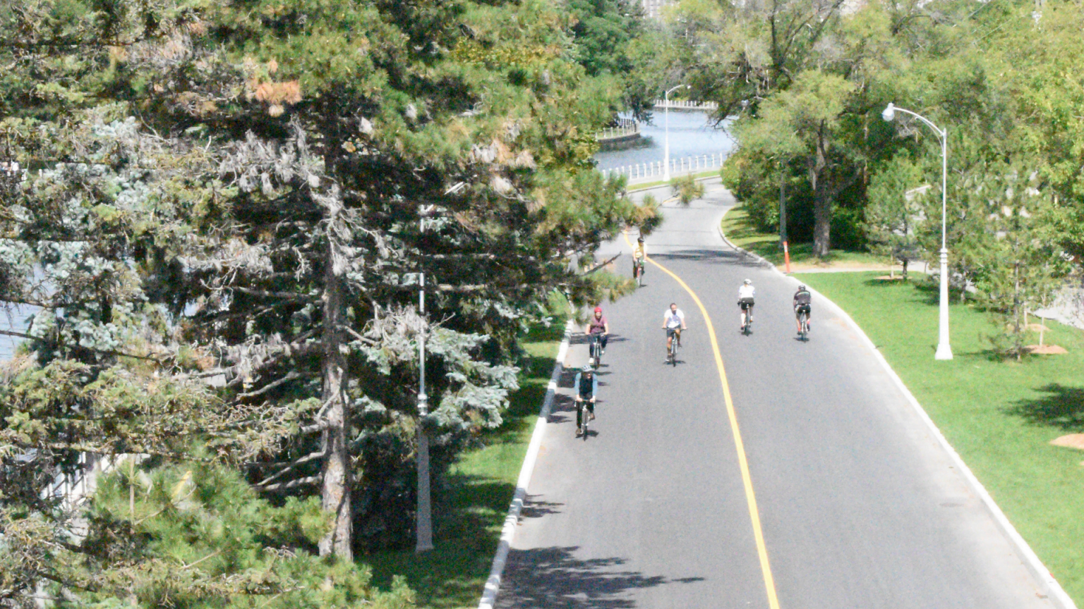 Cyclists riding on a path next to the Rideau Canal