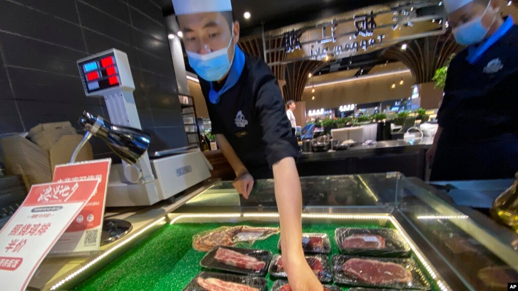 北京一名超市工作人员为牛肉贴上销售标签。2020年8月28日图片。